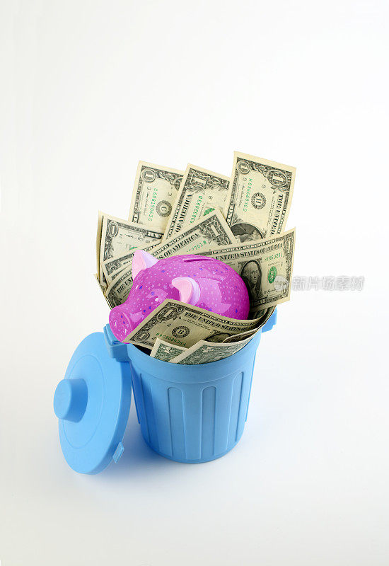 Piggy bank and moneys thrown in a garbage bin